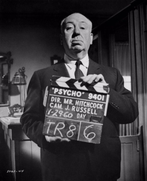 Alfred Hitchcock holding Psycho Clapper